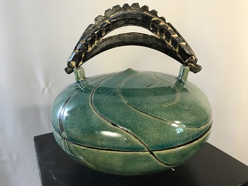 'Kisbah container,' Wheel thrown and high fired with green crackle and tape resist design. 20 inches diam. x 9 inches ht., by Joel Moses